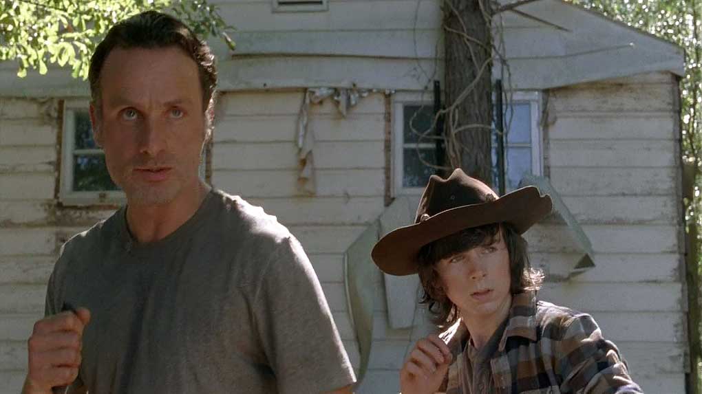 Rick and Carl defend against walkers