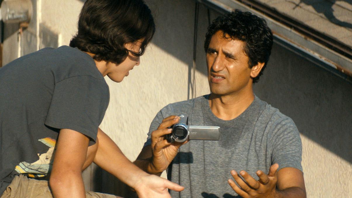 Travis (Cliff Curtis) and Chris (Lorenzo James Henrie) discuss the flashing light in the distance.